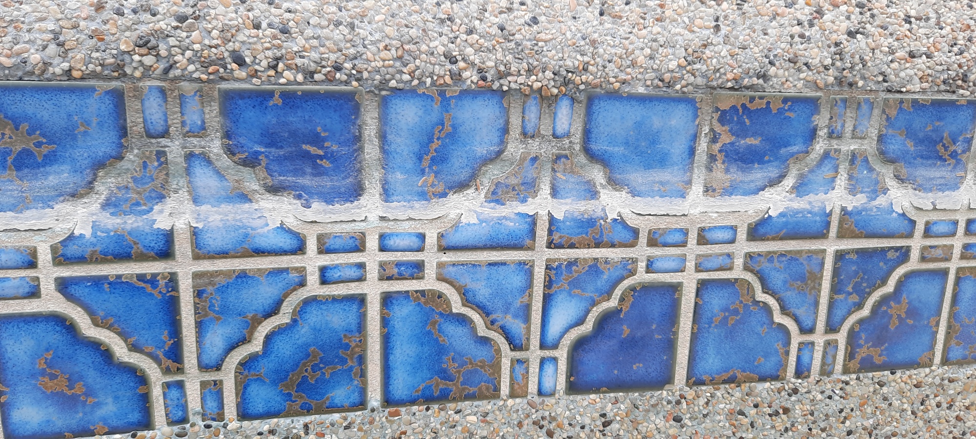 Blue speck pool water line before dustless blasting