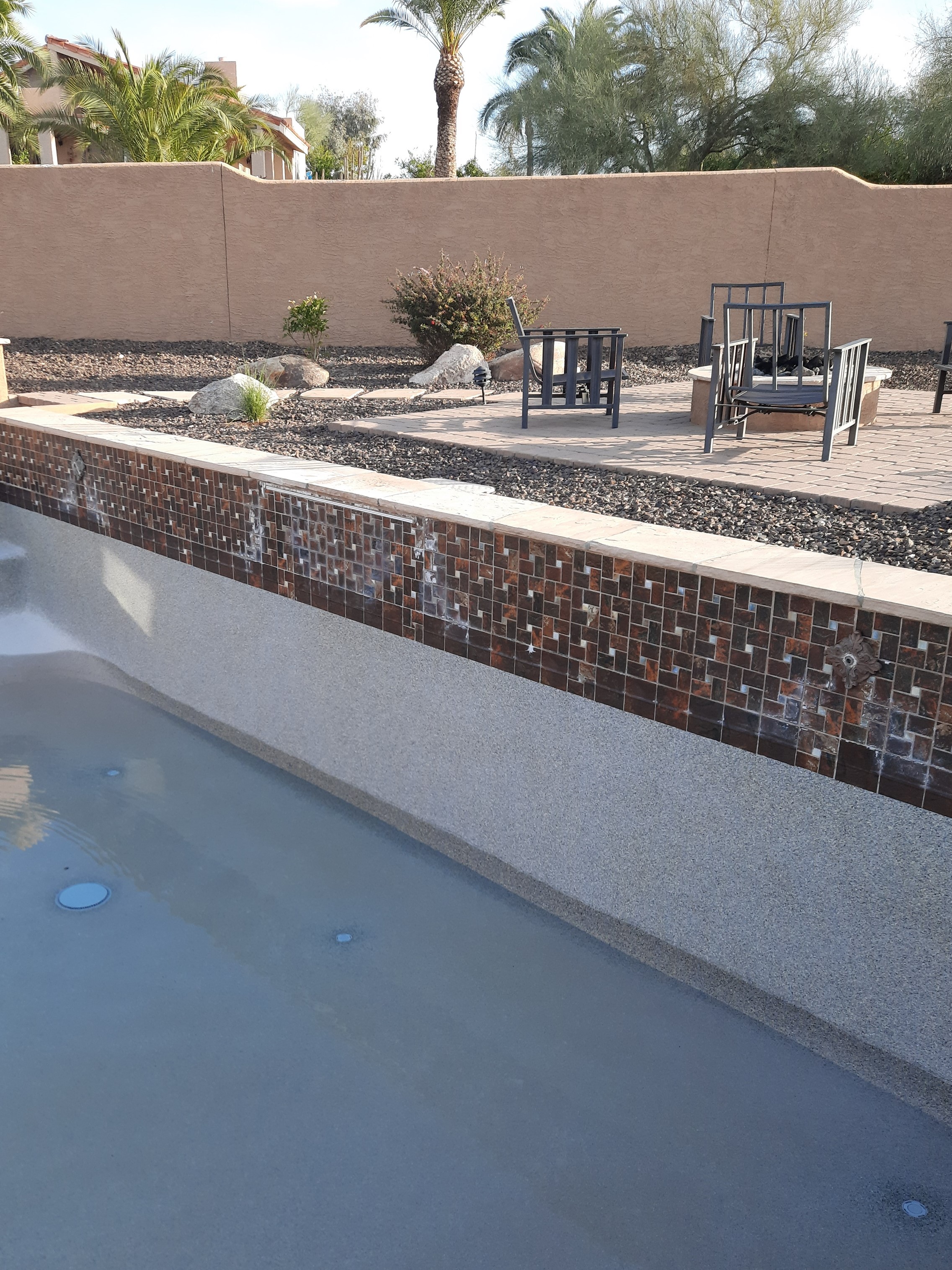 Brown pool water line before dustless blasting