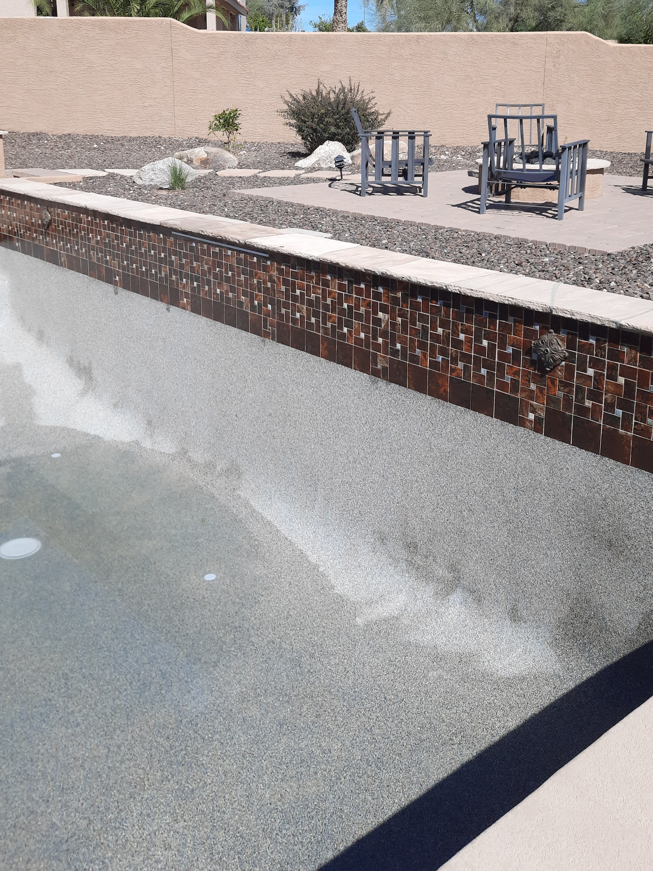 Brown pool water line after dustless blasting